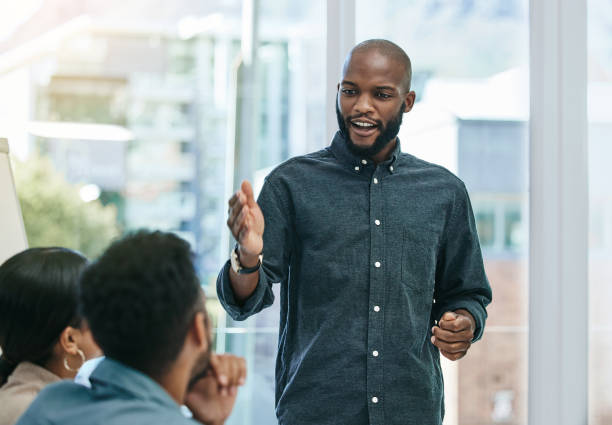 Shot of a businessman giving a presentation during a business meeting I believe this is the right direction for us showing stock pictures, royalty-free photos & images