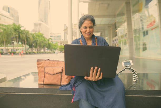 istock Woman Using Laptop Near Shopping Mall 1322306459