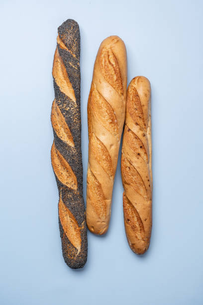 istock Fresh baguettes on blue background 1322306585