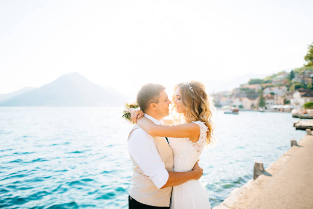 istock Couple Standing Near Sea Against Sky 1322306665