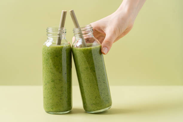 istock Green smoothie in glass bottles with bamboo tubes 1322306742