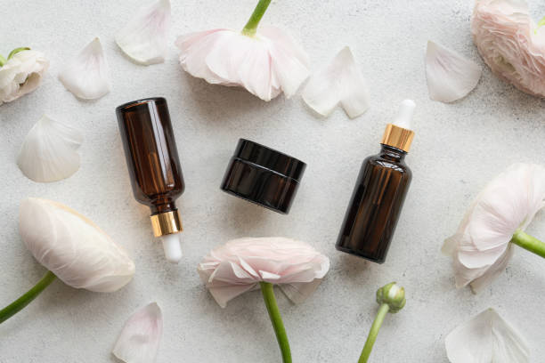 istock Serum and face cream on light background with  flowers 1322307082