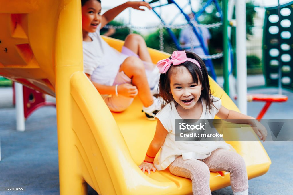 Sisters playing together in the park Child Stock Photo