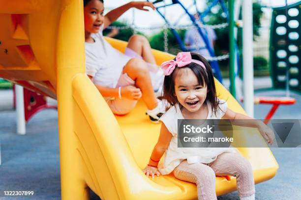 Sisters Playing Together In The Park Stock Photo - Download Image Now - Child, Playing, Playful