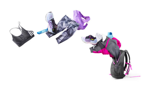istock Sportswear flies into an open backpack isolated on white background 1322311003