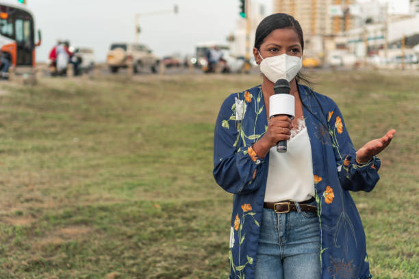 istock Female reporter wearing mask 1322311684