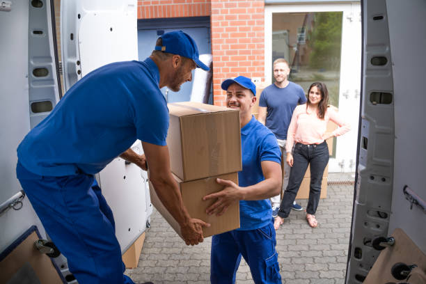 istock Happy Family Couple Watching Movers Unload Boxes 1322313617