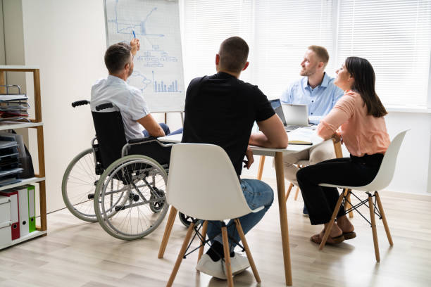 istock Wheelchair And Disability At Office. Giving Presentation 1322313705