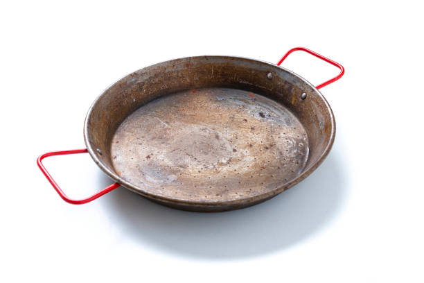 Old rusty paella pan isolated on white background