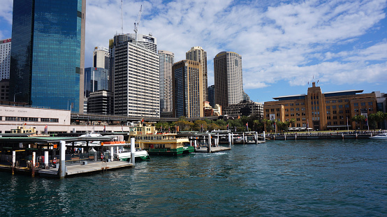 Sydney, Australia -22 Aug, 2015: Sydney city central business district view from harbor ferry over bay blue skyline. The city receives 7.5 million domestic overnight visitors every year.