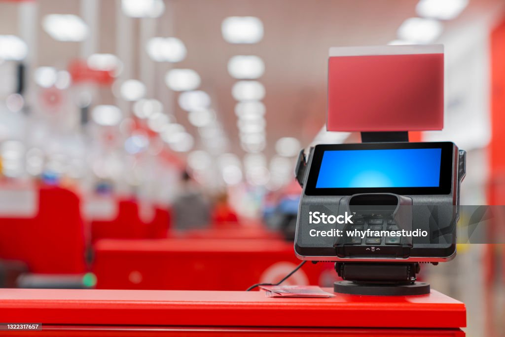 A POS machine at Woolworths Supermarket's self-serve checkout area with blur bokeh background Point Of Sale Stock Photo