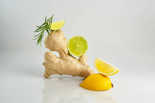 istock Fresh ingredients for summer refreshment. Lemon slice, lime, ginger and rosemary branch on grey background. Healthy lemonade with vitamins. 1322318127