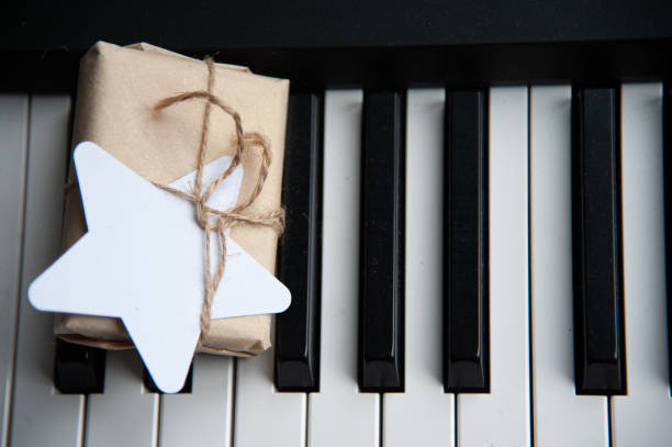 istock A small package with a gift lies on the black piano keys. View from above. 1322319687