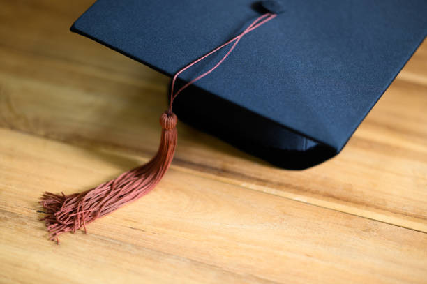 istock Close up of graduation cap pace on wood background 1322320633
