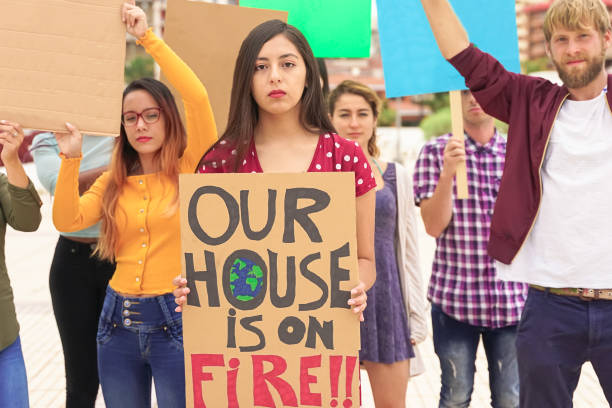 istock People protesting against multicultural opinion. Young people from different countries showing their ideology. Students together under same defense. There are unwritten posters - Image 1322322463