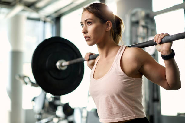 istock Determined female athlete having weight training in a gym. 1322322558