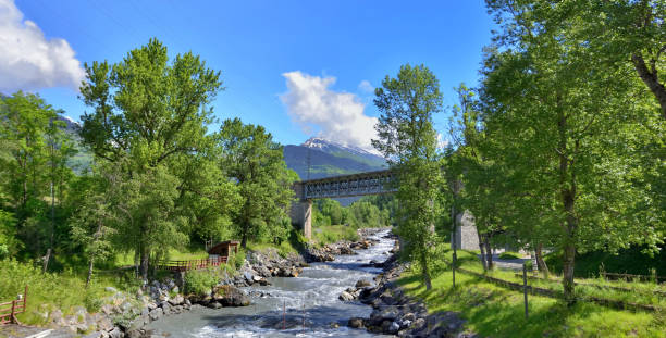istock flowing  water of a river crossing an alpine valley 1322322591