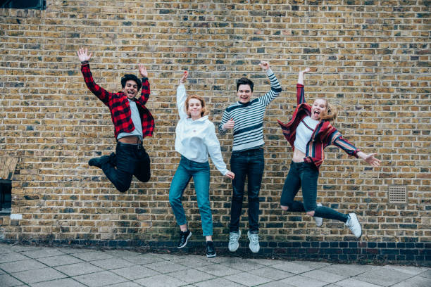 istock Happy teens jumping together 1322324649