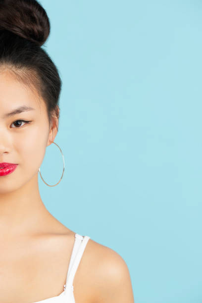 istock Asian young woman's portrait isolated over color studio background with copyspace 1322325784