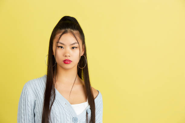 istock Asian young woman's portrait isolated on color studio background with copyspace for ad. 1322325785
