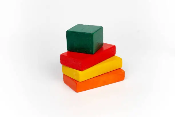 4 painted blank wooden toy blocks on white background