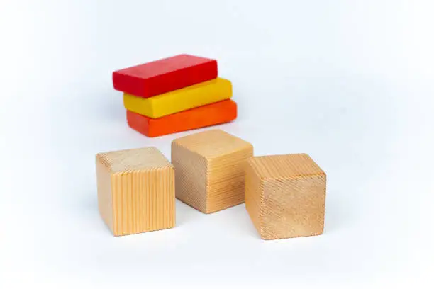 3 natural and 3 colorful blank wooden toy blocks on white background
