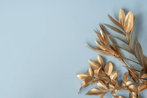 istock golden leaves on blue pastel background 1322327261
