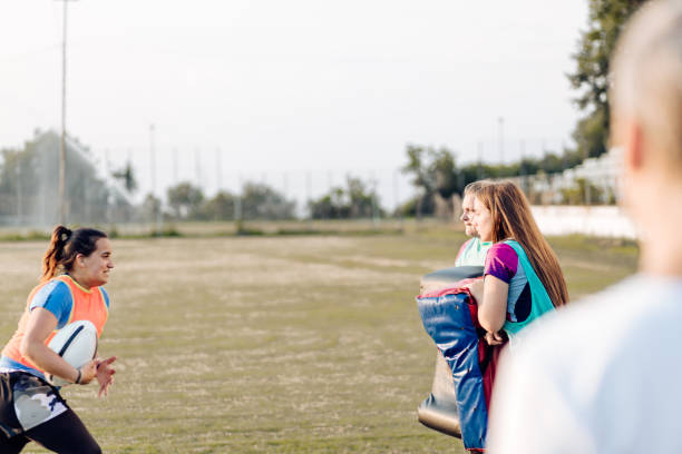 istock Girls in a rugby team practicing attack on the training 1322327478