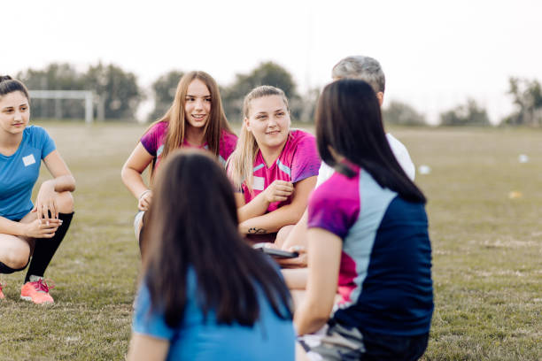 istock Girls from a rugby team planning a training with their coach 1322327482