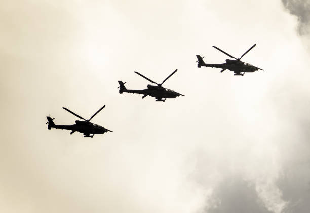 Three helicopters in flight. Military helicopters. Cloudy sky in the background. military parade stock pictures, royalty-free photos & images