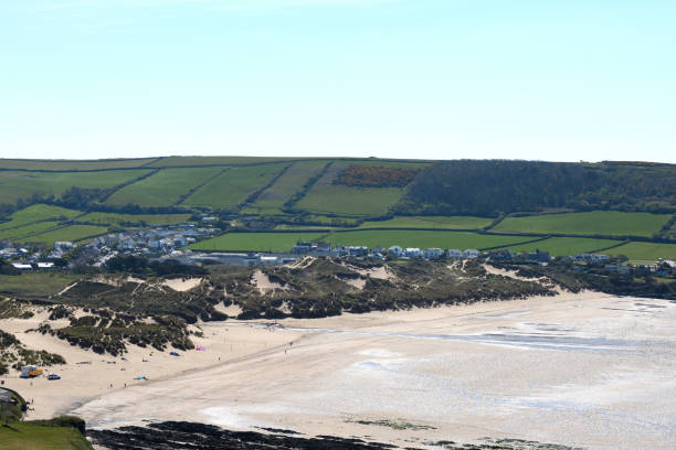 Sand dunes at Croyde Bay Devon. The sand dunes are on the left of the photo and the beach is on the right. The photo is taken from Baggy Point and shows Croyde Bay. Croyde Bay is a famous surfing beach in north Devon. It is situated in the south-west of the UK in an area often known as the West Country. It is a tourist destination. The photo was taken in April 2021. croyde bay photos stock pictures, royalty-free photos & images