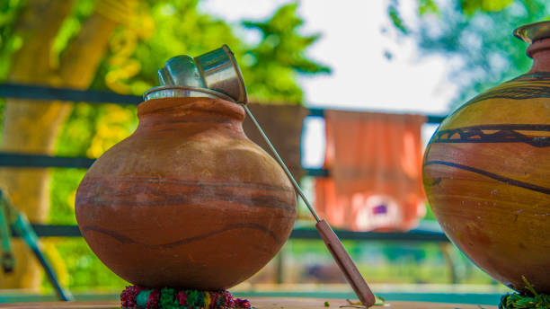 Two vintage clay jugs or pots on the natural background outdoors. stock photo