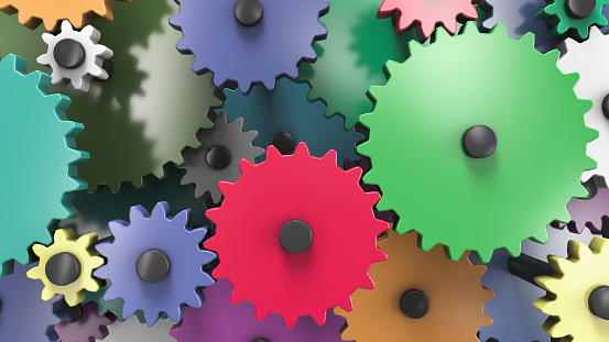 Multi-colored interacting gears. Full frame. Mechanical theme background