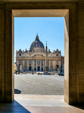 Vatican, June 03 -- The imposing facade of St. Peter's Basilica appears from under the colonnade of the palaces of Via della Conciliazione, in the historic heart of Rome. The Basilica is the center and symbol of the Catholic religion, one of the most visited places in the world for its immense artistic and architectural treasures and for its spiritual significance. Photo in High Definition format.
