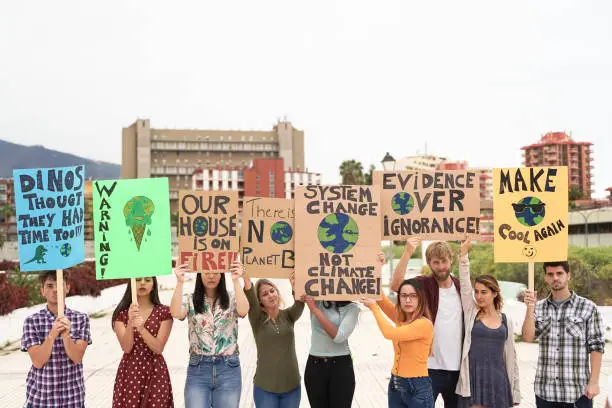 Photo of People protesting against climate change. Young people from different countries showing their ideology. Young together under same defense - Image