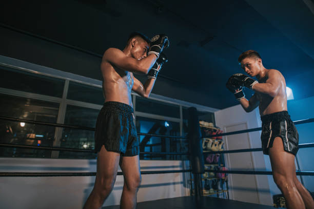 istock Muay Thai athletes training on the boxing ring match getting ready to fight 1322336248