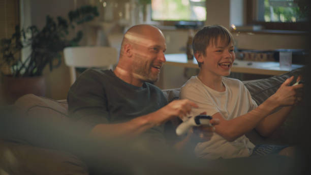 istock Screen time during pandemic. Father and son playing video games 1322336272