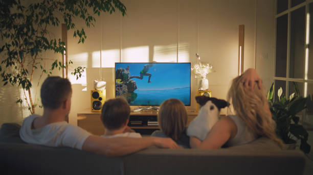 istock Watching tv at home. Family with two sons spending time together 1322336571