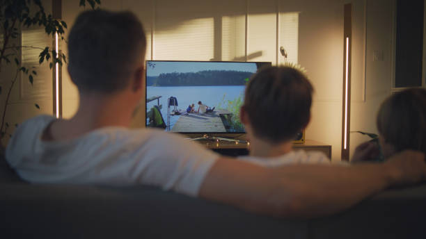 istock Screen time during pandemic. Father and sons watching TV 1322336633