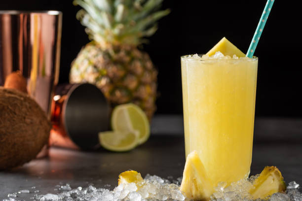 istock Cocktail with pineapple, coconut and lemon on stone background 1322337654