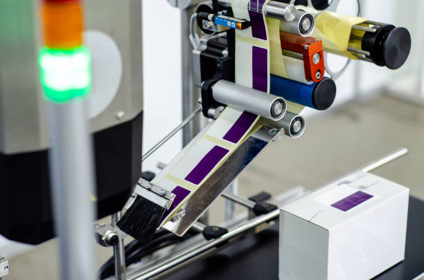 Close-up of  Automatic Sticker Labelling Machine Close-up of  Automatic Sticker Labelling Machine labeling photos stock pictures, royalty-free photos & images