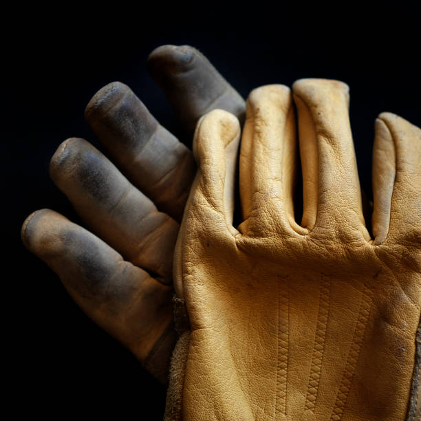 Detail of old worn leather work gloves workgloves texture
