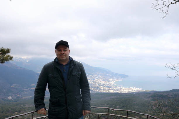 istock Man posing on observation deck of silver gazebo 1322339802