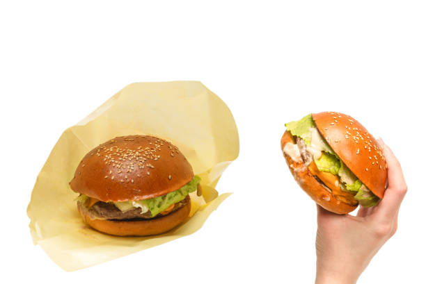 istock Hamburger in woman hands isolated on a white background. 1322344993