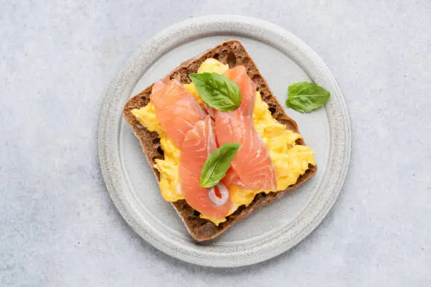Photo of Breakfast toast with scrambled eggs and smoked salmon Lox