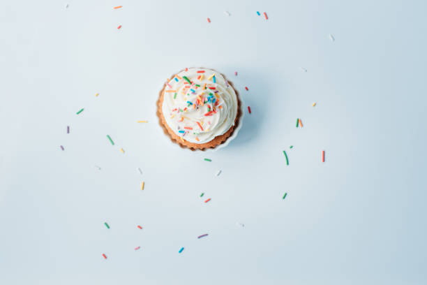 istock Homemade cupcake with colorful sprinkles on a white background. 1322349606