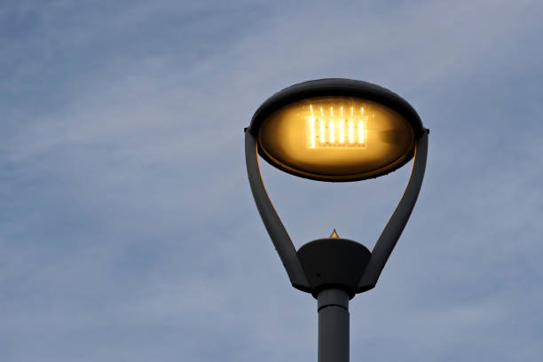 istock Glowing led lamp on blue sky with clouds background 1322351338