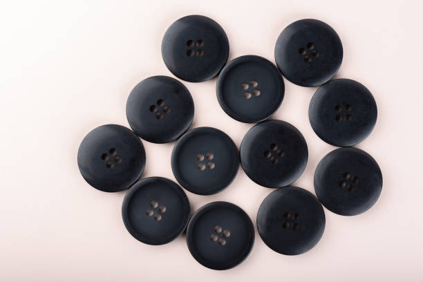 istock Top view of several sewing buttons on a light beige background. 1322351616