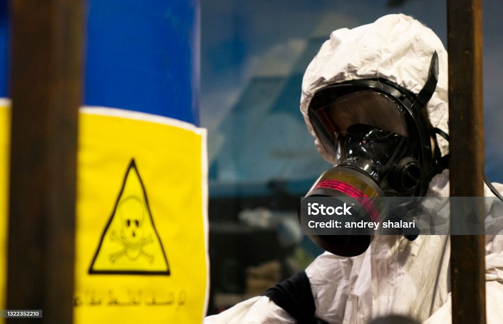 People in protective suits in the laboratory for the production of chemical and biological weapons. People in protective suits in the laboratory for the production of chemical and biological weapons. The threat of the use of weapons of mass destruction by Arab States. Biochemical Weapon Stock Photo