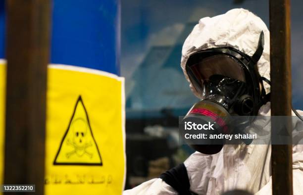 People In Protective Suits In The Laboratory For The Production Of Chemical And Biological Weapons Stock Photo - Download Image Now